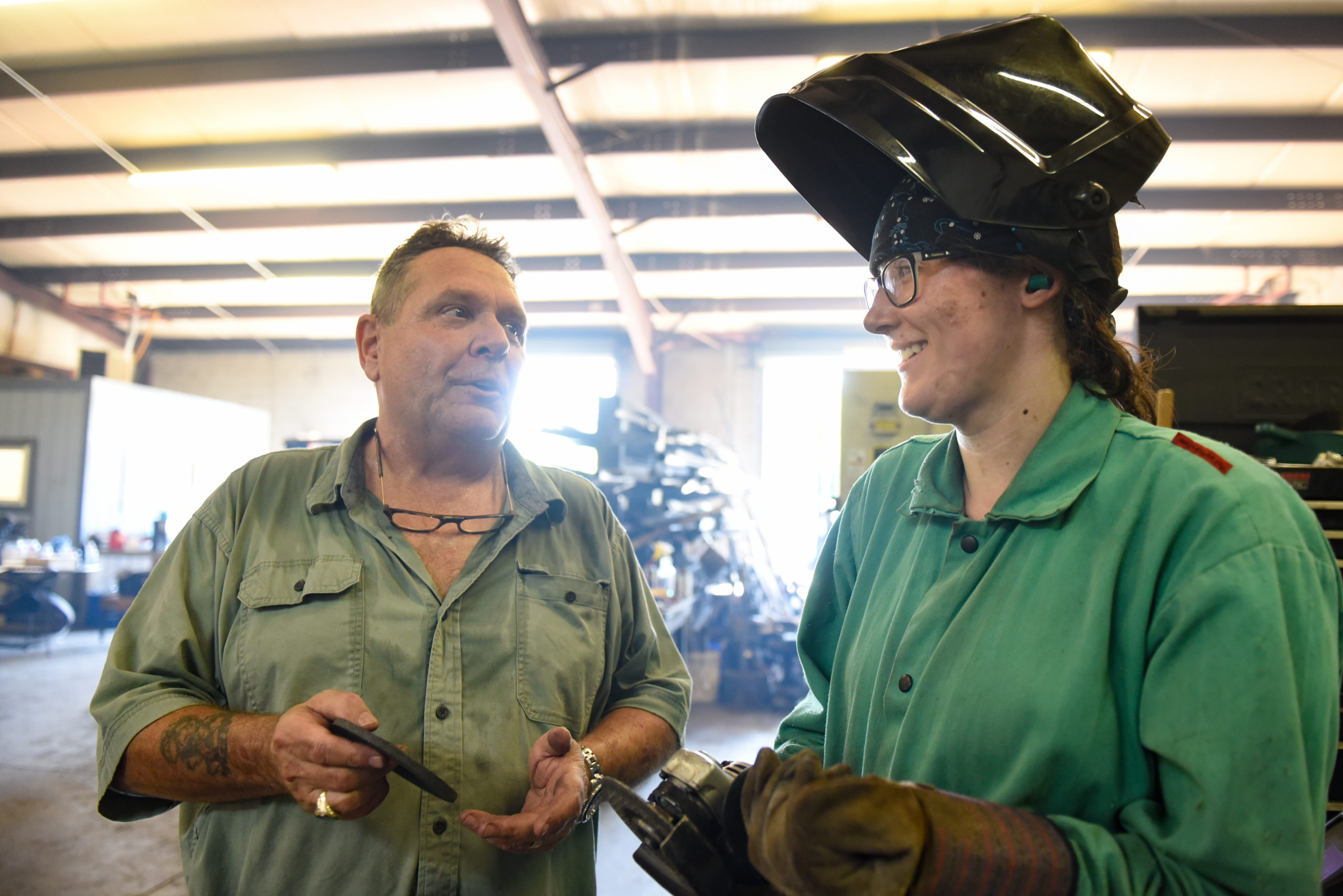 Female welder talking shop