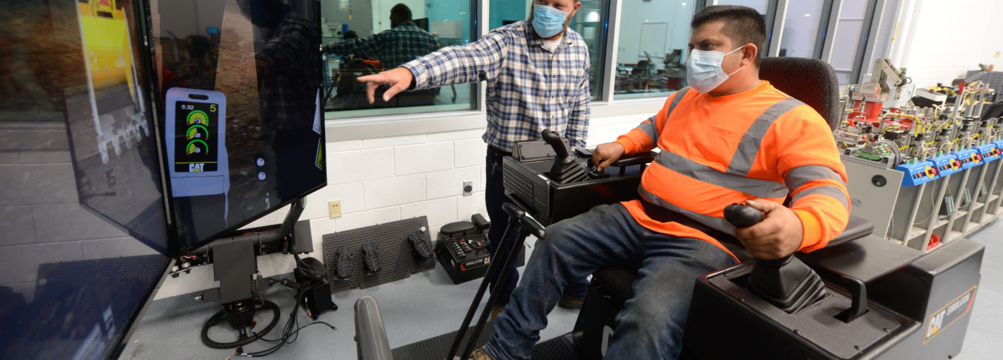 Student and instructor in PPE doing a simulator training