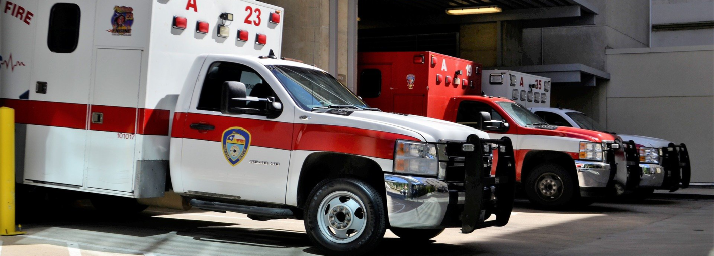 Three ambulance vehicles parked in a garage