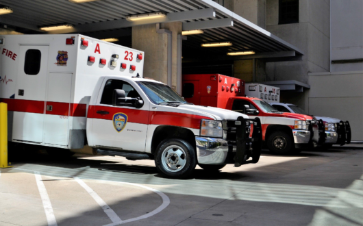 Three ambulance vehicles parked in a garage