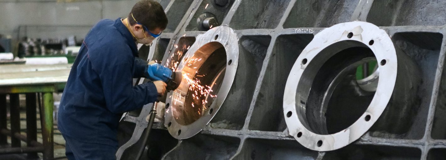 Worker welding metal for a ship