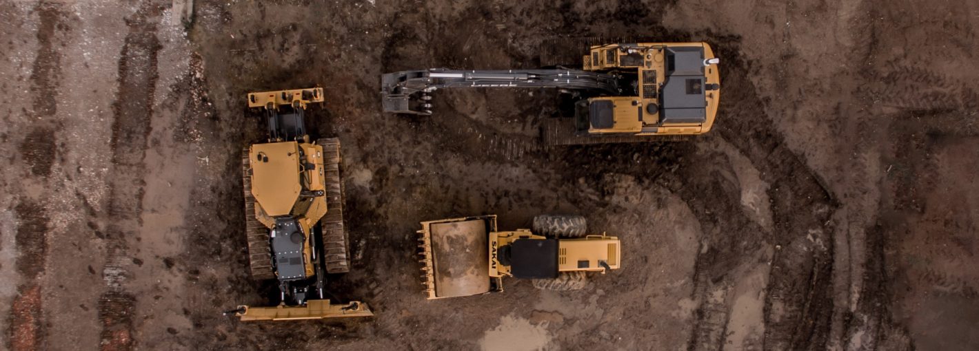 Overhead drone still of heavy equipment on a work site